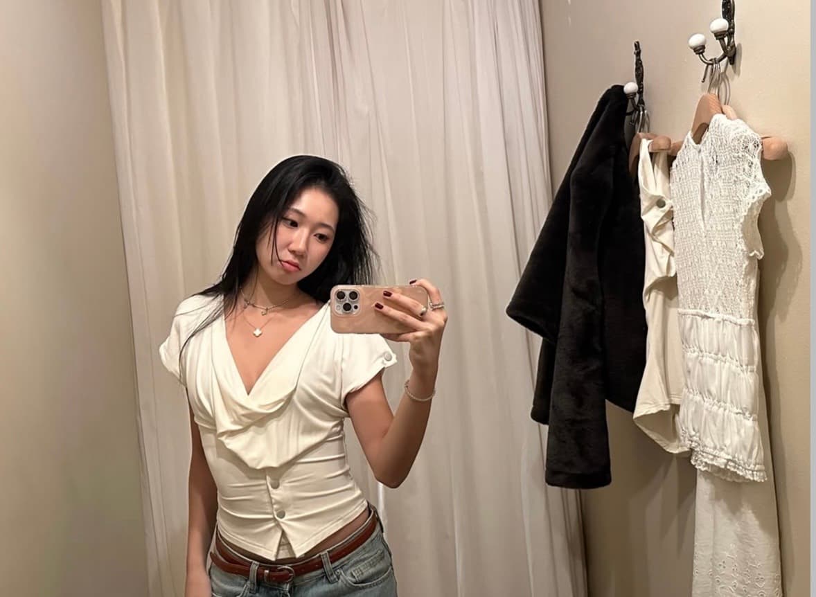 Yoolim Kim taking a mirror selfie in a fitting room